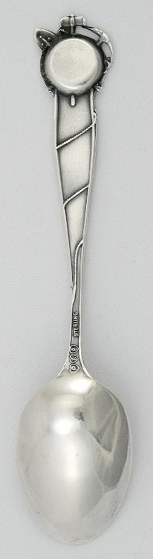 Souvenir Mining Spoon Reverse Boise, Idaho.jpg - SOUVENIR MINING SPOON BOISE IDAHO - Sterling souvenir spoon with a figural miner's pan and tools on the end of the handle, spoon measures 5 5/16" long and weighs 0.60 troy ounces, bowl features an embossed view of three men panningfor gold, scene is entitled, "Struck it Rich", bottom of the bowl is engraved "Boise, Idaho",  reverse of spoon is marked with the trademarks for Paye & Baker and "Sterling".  [Boise, the capital of Idaho, had its beginnings in the Idaho gold rush of the early 1860s.  In 1834 Fort Boise, owned by the Hudson Bay Company, was established by British fur traders. The fort, now known as Old Fort Boise, was located at the mouth of the Boise River, 40 miles from present day Boise. In 1854, due to frequent Indian raids, the fort was abandoned. With the discovery of gold in the Boise Basin in 1862, a new Fort Boise was built in 1863 to help protect the influx of gold seekers.  A town site was located next to the fort, and with the protection of the military, the new town of Boise grew quickly.  Its location on the Oregon Trail coupled with routes to the nearby gold mines made Boise a prosperous commercial center.  In 1864 the territorial legislature incorporated Boise and made it the capital of the Idaho Territory.  With Idaho statehood in 1890, Boise became the state’s capital.  Placer deposits of gold were first discovered about 25 miles northeast of Boise in 1862 and soon additional deposits, including significant numbers of lodes, were found covering the mountainous land known as the Boise Basin.  Boise Basin was divided into several mining districts and it covered an area of 300 square miles.  Some of the most notable districts were Idaho City, Moore Creek, Centerville, Quartzburg, Pioneerville and Grimes Pass.  All these districts and deposits yielded over 2,800,000 ounces of gold between the years of 1863 and 1959.  The placer deposits were worked first by large hydraulic washers.  Sometimes entire hillsides were washed away.  Lode work was more erratic and less dependable; miners would work lodes for a few years until another fresh deposit was discovered in a different mining district within the Boise Basin and they would pull up stakes and move on.  Mill sites worked in a similar way.  Whole operations would be dismantled and reassembled again and again around the Boise Basin.  The height of the boom lasted from 1863 to 1866. By 1867 many sold out to Chinese miners who were able, through industrious work, to make the mines pay.  Quartz mining prospered in the 1870s with a number of stamp mills in operation.   Dredge mining began in 1898 and continued till the 1950’s. The Boise Basin was the richest gold strike ever seen in America.  More gold was taken out of the land during this rush than the California 49er or the Klondike gold rush – it’s estimated that more than $250,000,000 was taken from this area in the two decades following its discovery.]  